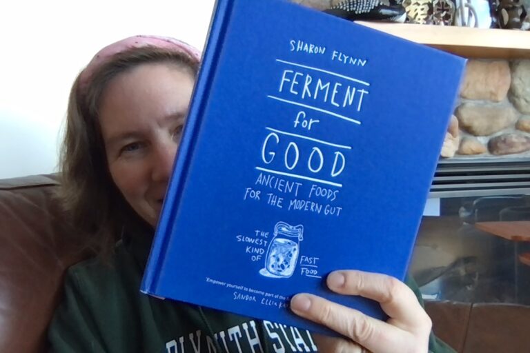 Photo of someone holding a book titled Ferment for Good: Ancient Foods for the Modern Gut by Sharon Flynn.