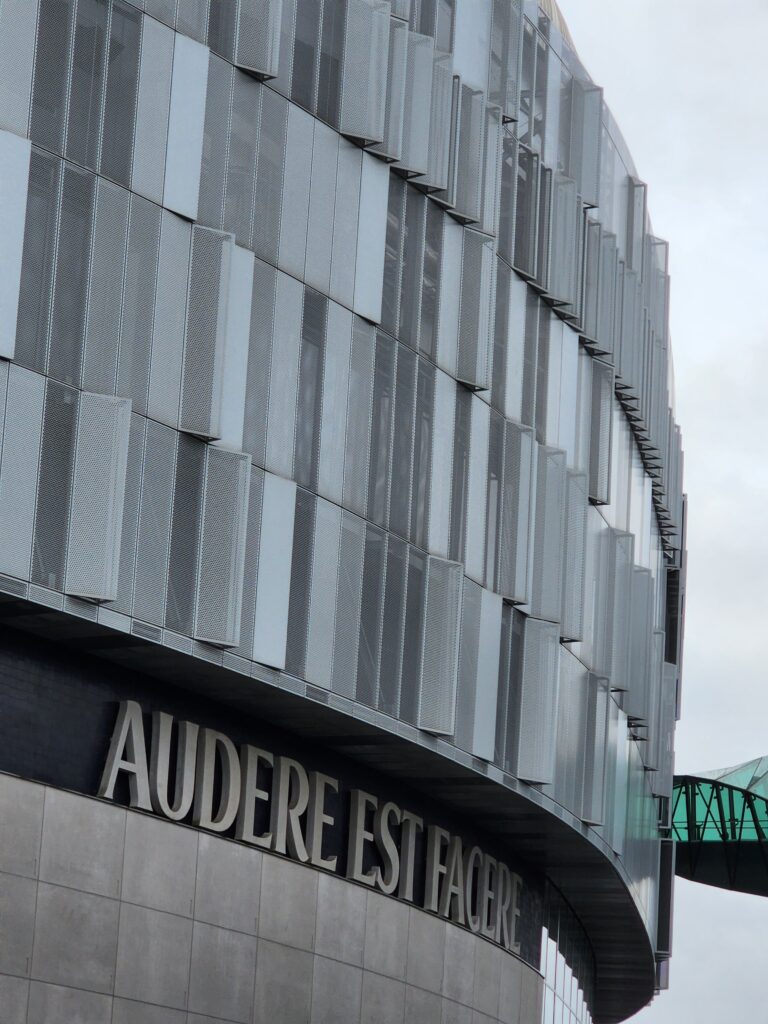 Photo of a building labeled Audere Est Facere.