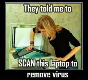 Photo of a woman photocopying a laptop, with the caption "They told me to SCAN this laptop to remove virus".