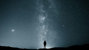 Image of a person looking up at a star filled sky.